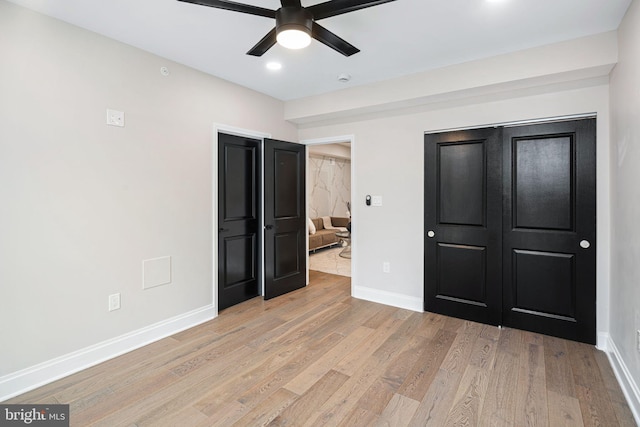 unfurnished bedroom featuring ceiling fan and light hardwood / wood-style floors