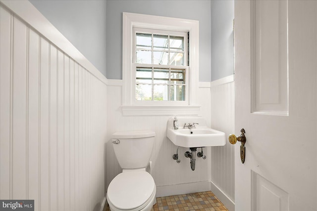 bathroom with tile patterned flooring, sink, and toilet