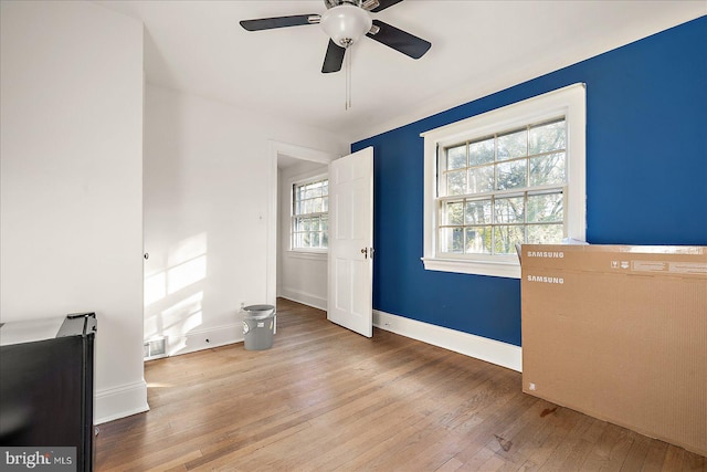 interior space with hardwood / wood-style floors and ceiling fan