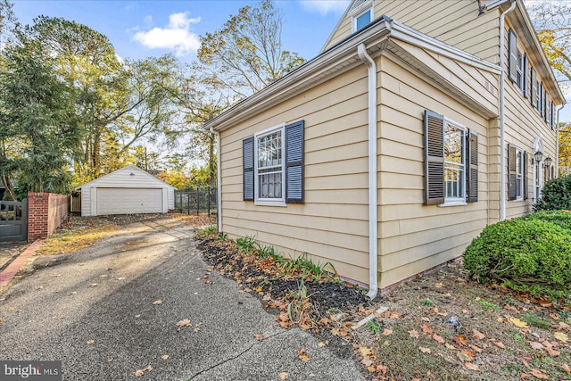 view of side of property with a garage and an outbuilding