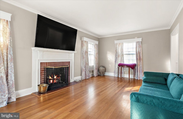 living room featuring hardwood / wood-style floors, a fireplace, and ornamental molding