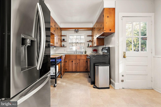 kitchen featuring appliances with stainless steel finishes, a healthy amount of sunlight, and sink