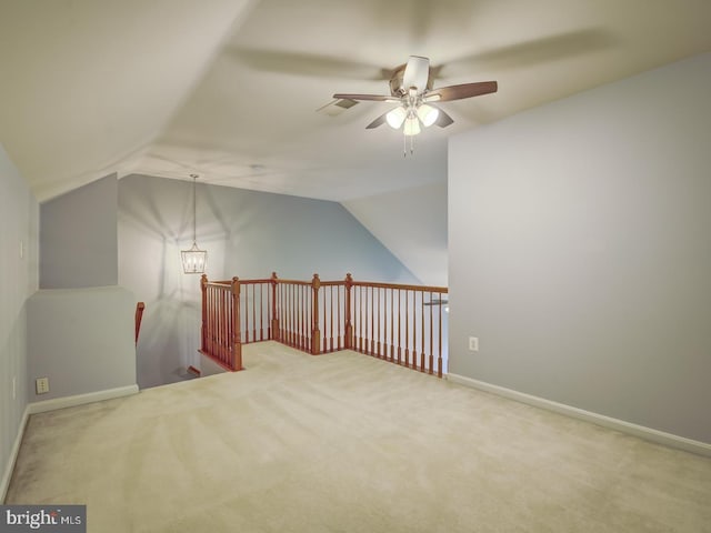 additional living space with carpet, baseboards, vaulted ceiling, and ceiling fan with notable chandelier