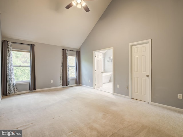 unfurnished bedroom featuring carpet floors, multiple windows, and baseboards