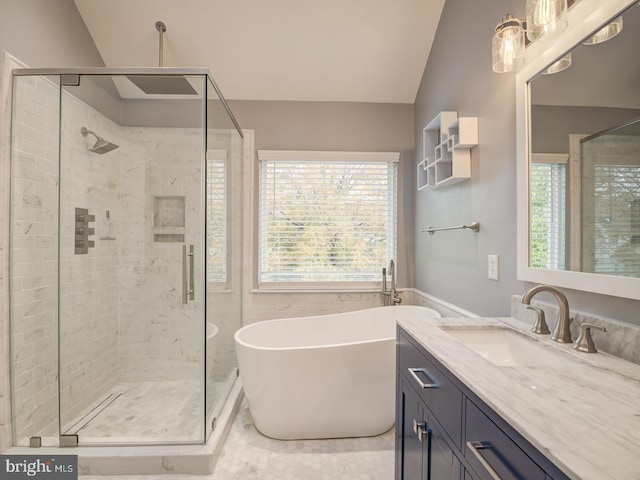 full bathroom with lofted ceiling, a stall shower, a freestanding bath, and vanity