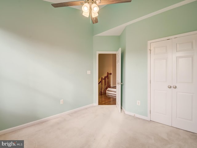 unfurnished bedroom featuring ceiling fan, carpet floors, a closet, and baseboards