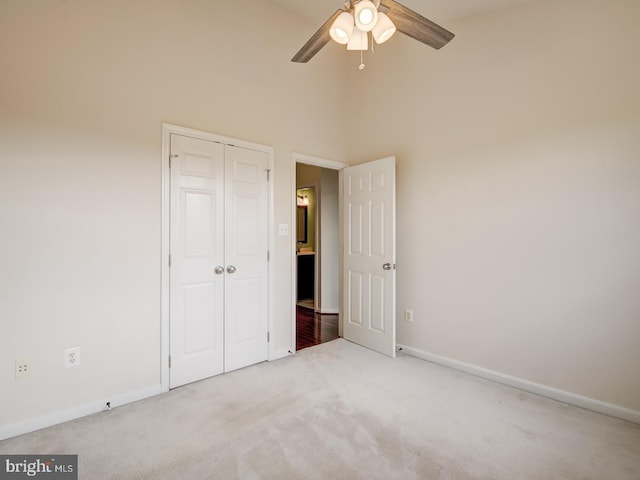 unfurnished bedroom featuring carpet floors, a closet, and baseboards