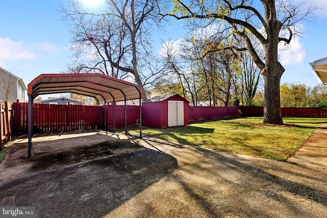 view of yard with a carport and a storage shed