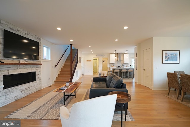 living room with a fireplace and light hardwood / wood-style flooring