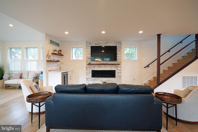 living room with plenty of natural light, wine cooler, and light wood-type flooring