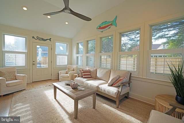 sunroom with lofted ceiling, a healthy amount of sunlight, and ceiling fan