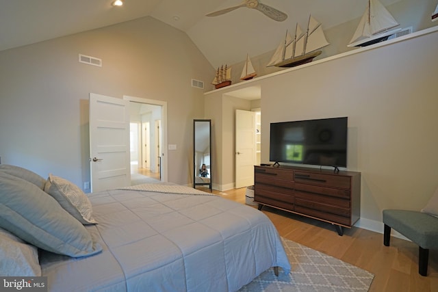 bedroom with high vaulted ceiling, ceiling fan, and light hardwood / wood-style floors