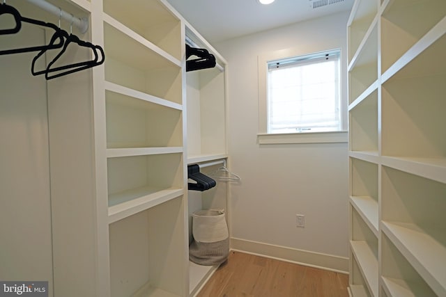 walk in closet featuring light hardwood / wood-style floors