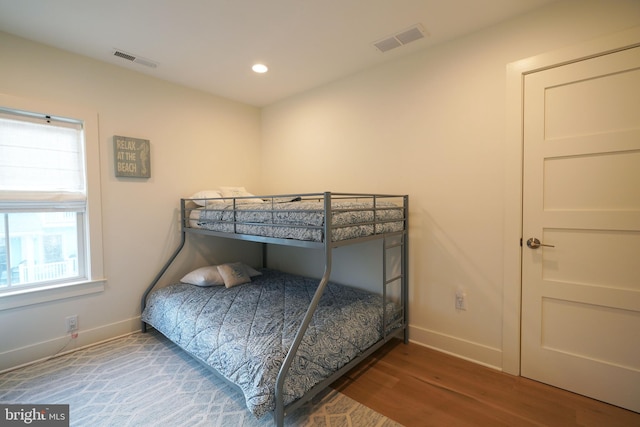 bedroom with hardwood / wood-style flooring