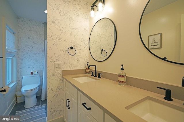 bathroom with tile patterned floors, vanity, and toilet