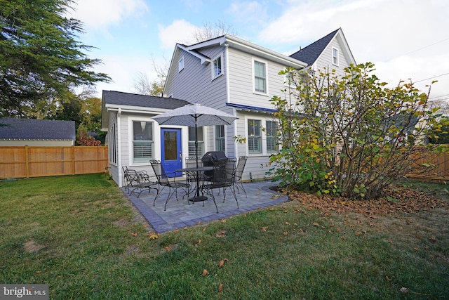 rear view of property featuring a yard and a patio area