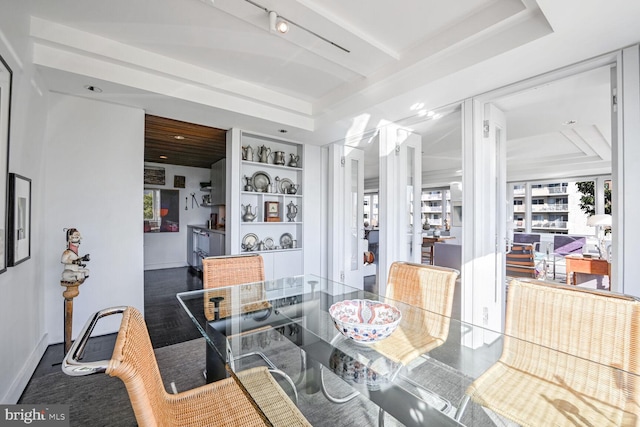 dining area featuring a tray ceiling, built in shelves, baseboards, and recessed lighting