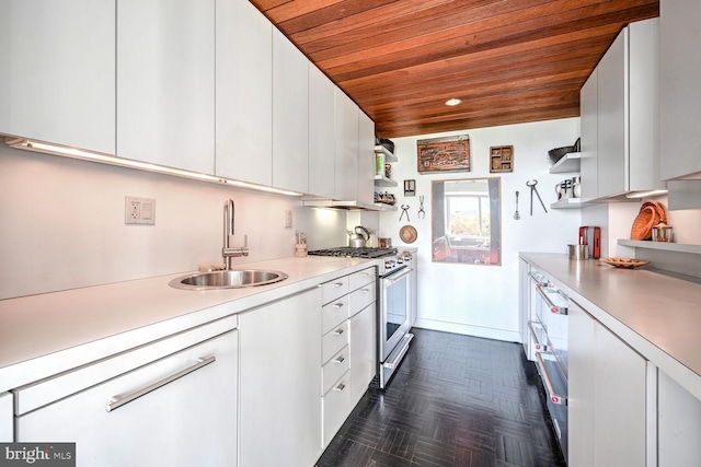 kitchen with open shelves, stainless steel range, a sink, wood ceiling, and light countertops