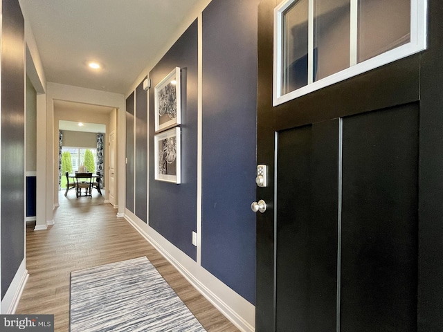 hallway with hardwood / wood-style floors