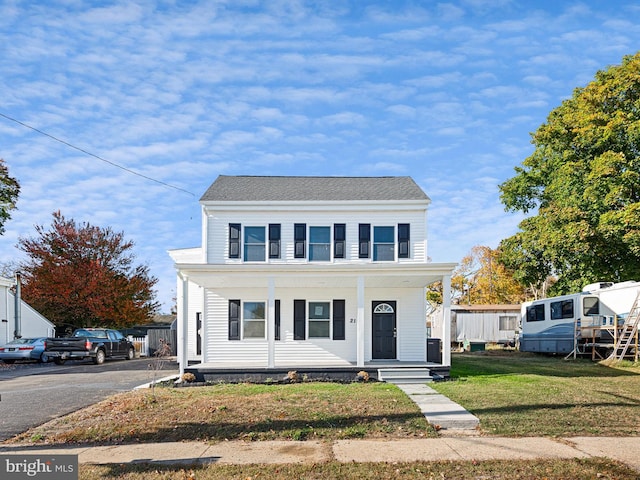 view of front of home featuring a front yard and covered porch