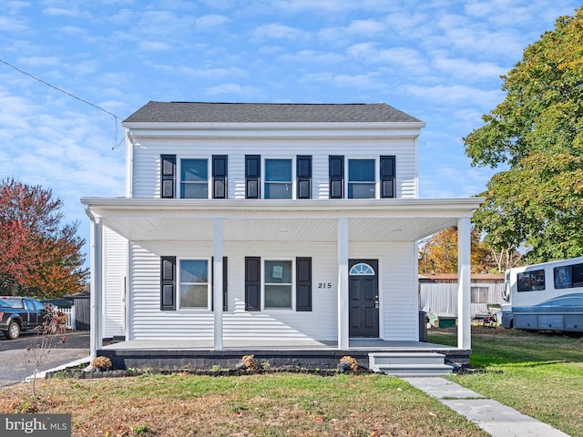 view of front facade with covered porch and a front yard