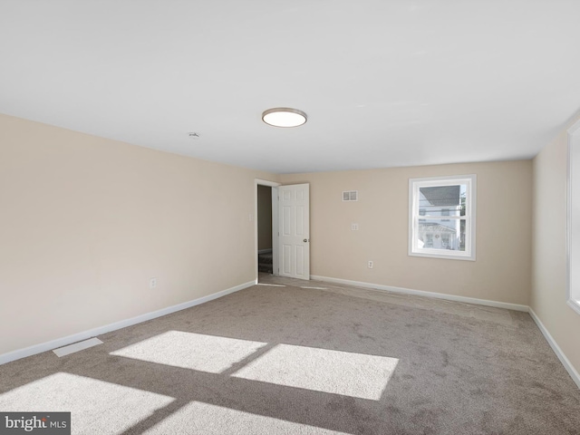 spare room with light colored carpet