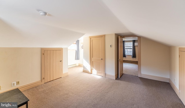 bonus room featuring baseboard heating, vaulted ceiling, and carpet