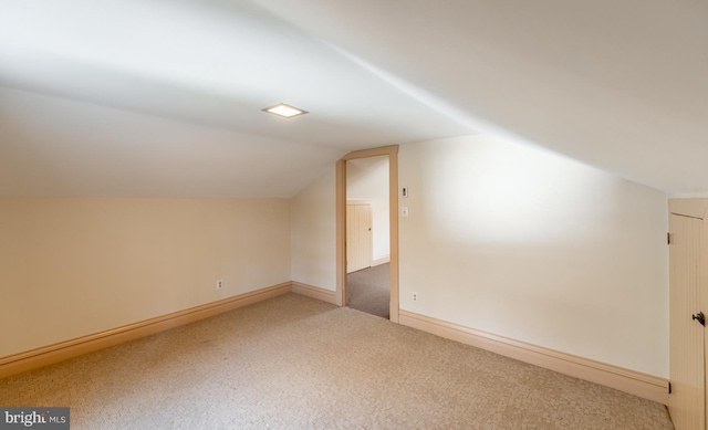 bonus room featuring vaulted ceiling and carpet floors