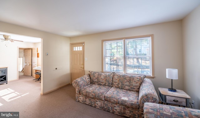 living room featuring light colored carpet and ceiling fan