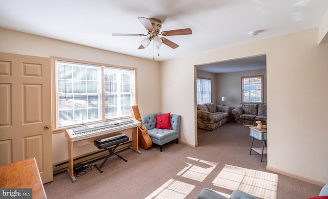 sitting room featuring light colored carpet and ceiling fan