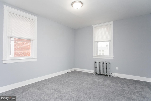 carpeted spare room with radiator