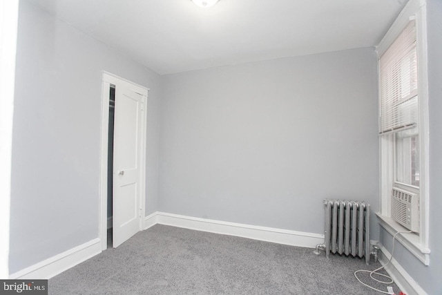 unfurnished bedroom featuring carpet and radiator