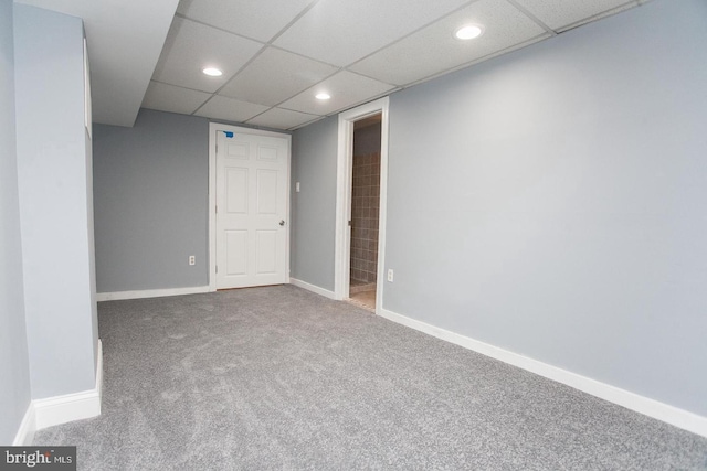 basement with carpet floors and a drop ceiling