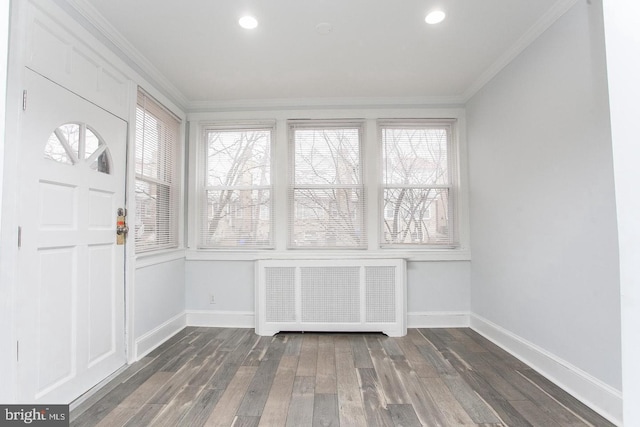 unfurnished sunroom featuring radiator and a wealth of natural light