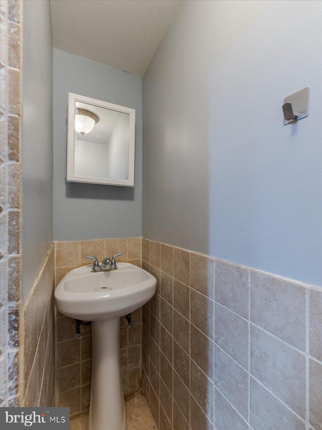 bathroom with tile walls