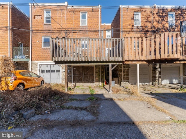 rear view of property featuring a wooden deck