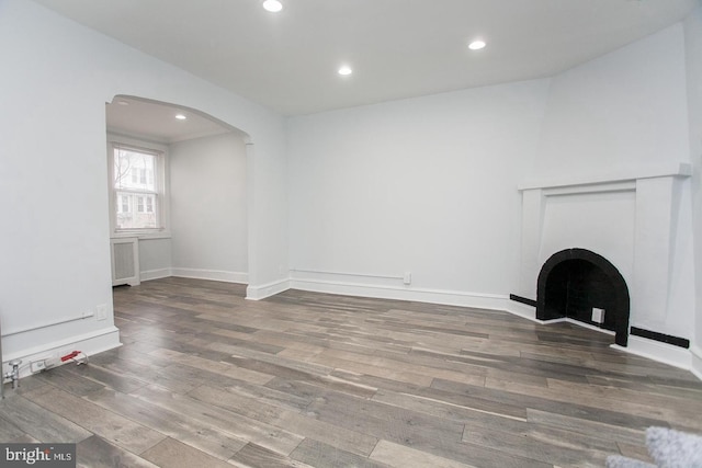 unfurnished living room featuring wood-type flooring