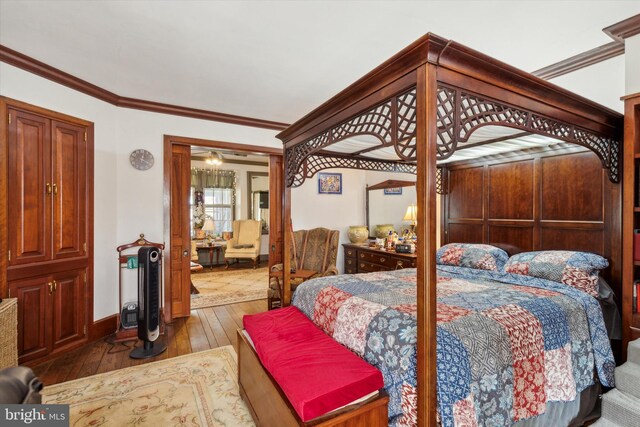 bedroom with ornamental molding and wood-type flooring