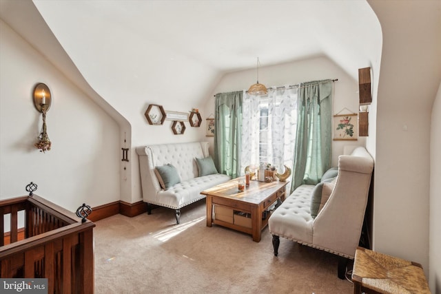 sitting room with light colored carpet and vaulted ceiling