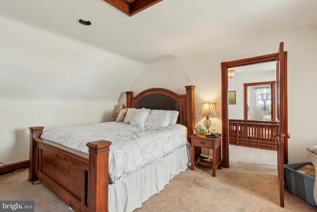 carpeted bedroom featuring lofted ceiling