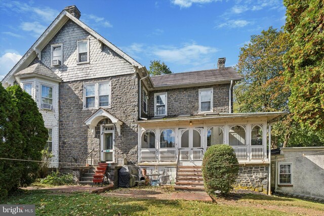 view of front of property featuring cooling unit and covered porch