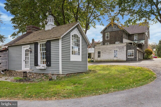 view of property exterior featuring a lawn