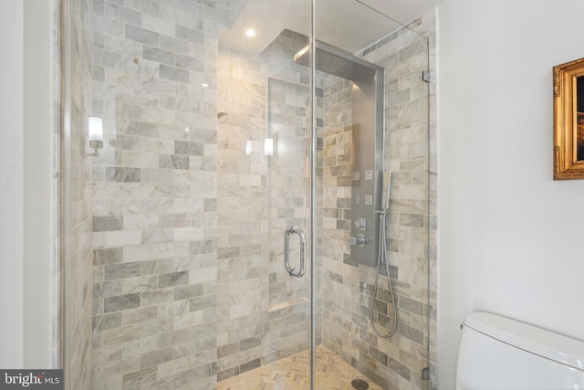 bathroom featuring toilet and an enclosed shower