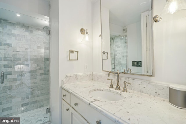 bathroom with walk in shower and vanity