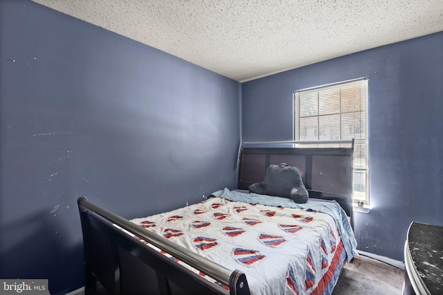 carpeted bedroom with a textured ceiling