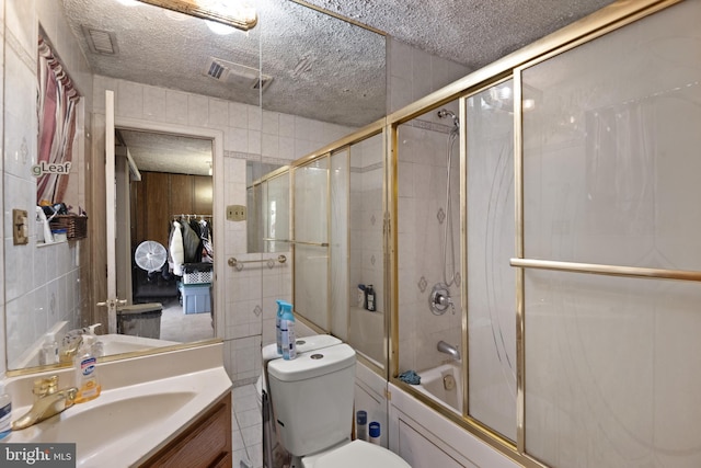 8600 Sapienza Dr, Fort Washington, MD 20744 - bathroom featuring shower / bath combination with glass door, vanity, a textured ceiling, and toilet