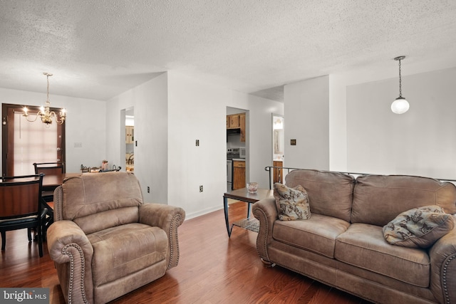 8600 Sapienza Dr, Fort Washington, MD 20744 - living room with a chandelier, wood finished floors, a textured ceiling, and baseboards