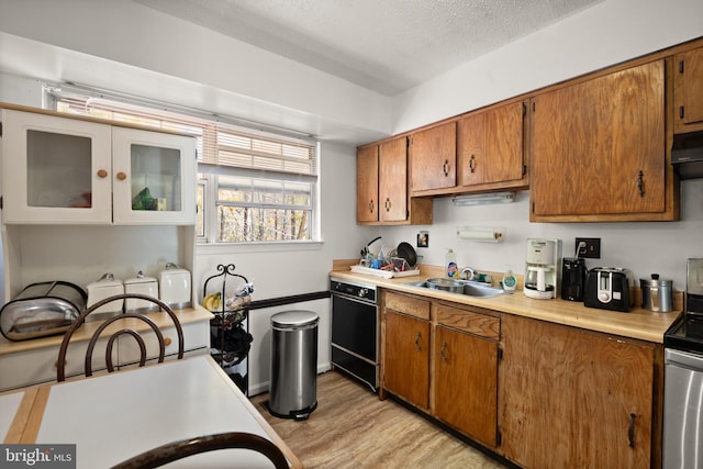 8600 Sapienza Dr, Fort Washington, MD 20744 - kitchen with a sink, dishwasher, brown cabinets, range, and light countertops