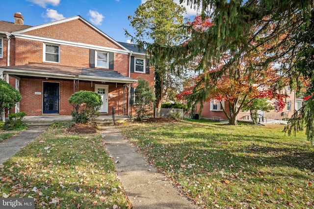 view of front of house featuring a front lawn and covered porch