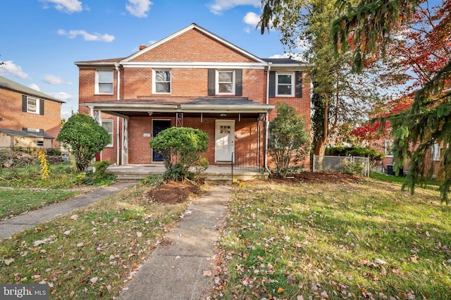 front of property featuring a front yard and covered porch